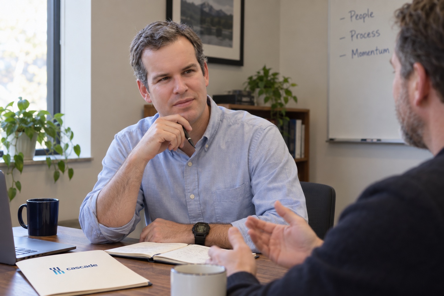 Two professionals in a one-on-one coaching conversation